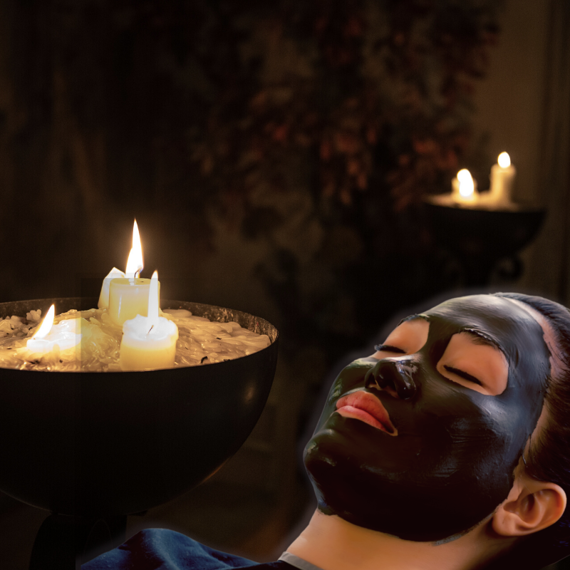 woman with mud mask and candles